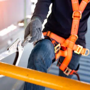 Assistant scaffolder working at construction site.